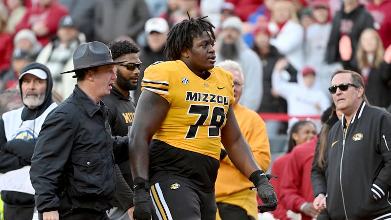Missouri offensive lineman Armand Membou (79) is escorted off the field after being ejected...