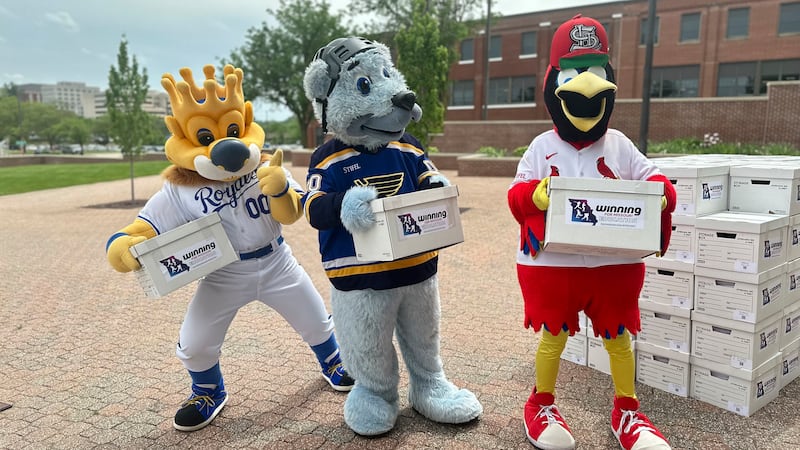 Mascots for the Kansas City Royals, St. Louis Blues and St. Louis Cardinals haul boxes of...