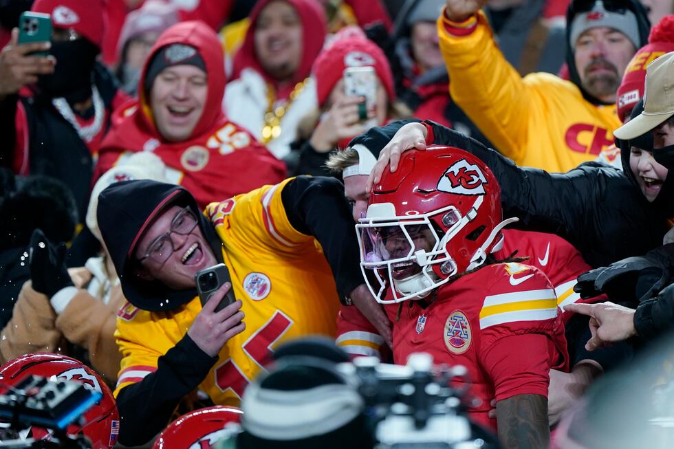Kansas City Chiefs wide receiver Xavier Worthy (1) is congratulated by fans after scoring...