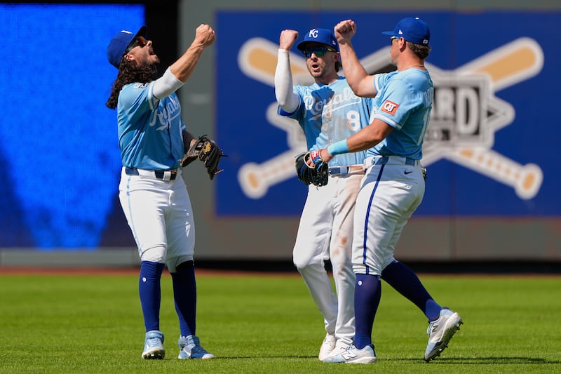 Kansas City Royals outfielders Jonathan India, left, Drew Waters (8) and Hunter Renfroe,...