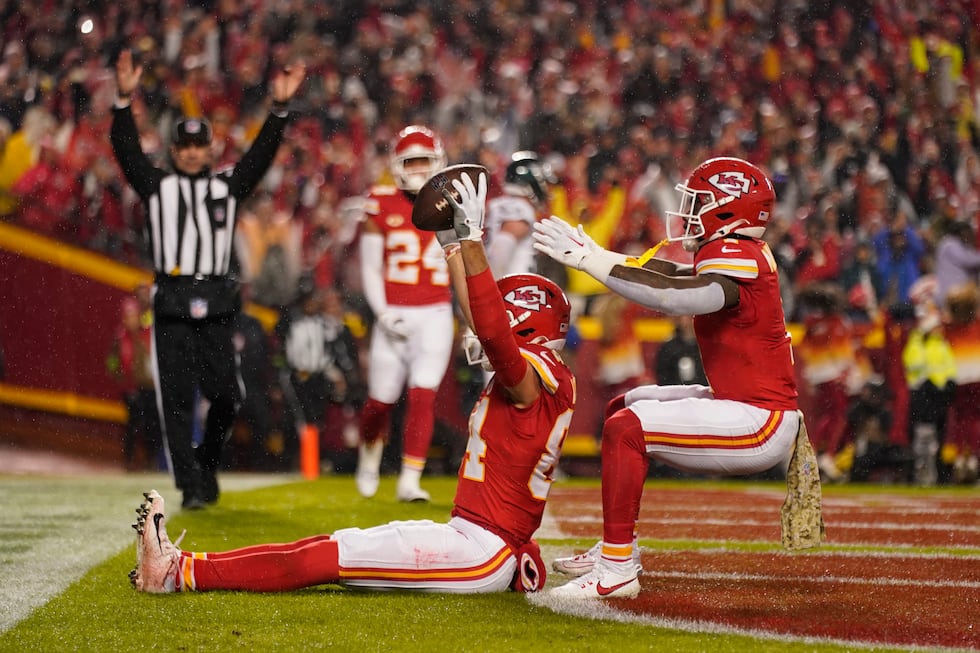 Kansas City Chiefs wide receiver Justin Watson is congratulated by teammate Jerick McKinnon,...