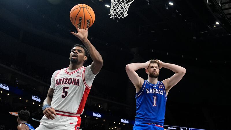 Kansas' Hunter Dickinson (1) reacts after fouling Arizona's KJ Lewis (5) during the second...