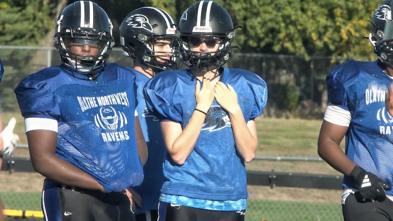 Among the sea of blue and black at Olathe Northwest football practice, you'll find Megan May.