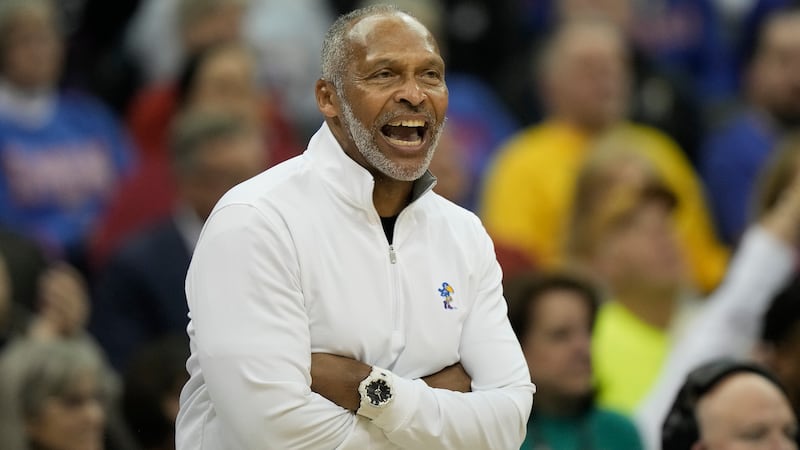 Acting Kansas head coach Norm Roberts talks to his players during the first half of the NCAA...