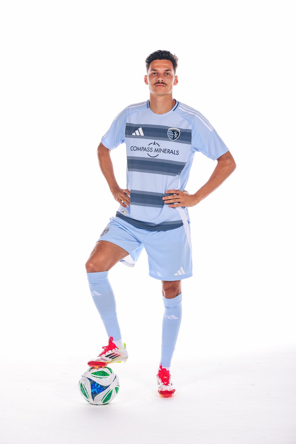 Sporting KC midfielder Daniel Salloi showcases the club's "One KC" uniforms.